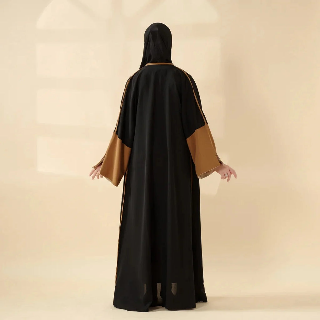 عباءة أنيقة تجمع بين الأسود والبني بتصميم يناسب كل مناسبة، من الارتداء اليومي إلى الاحتفالات الخاصة.